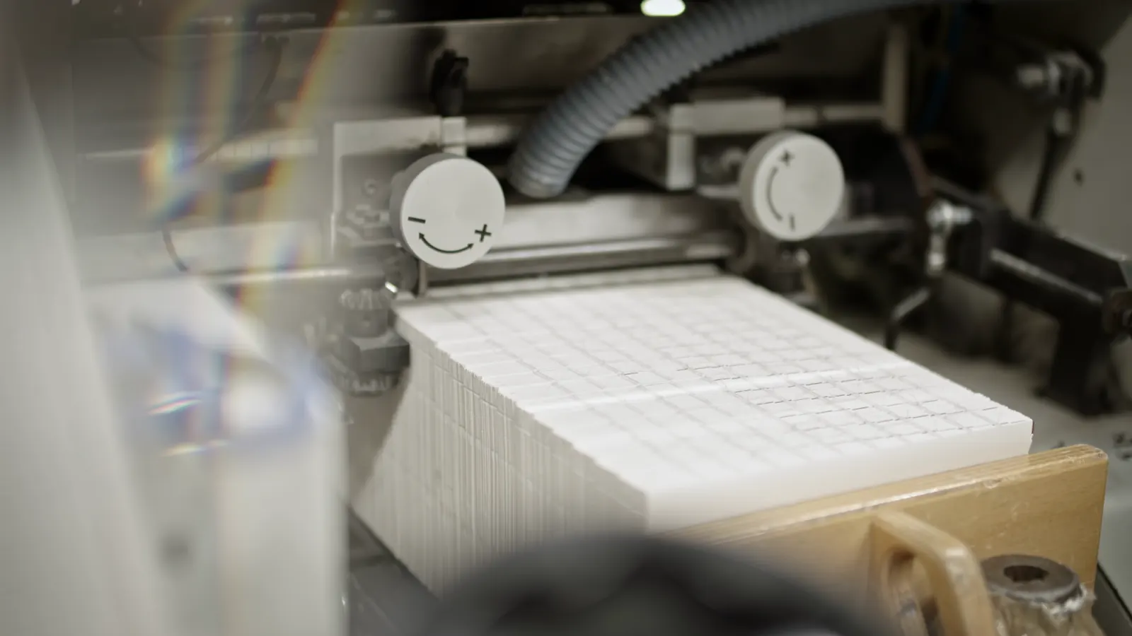 Folded signatures moving through a printing press.